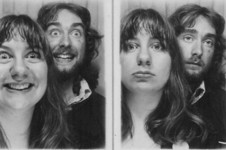 A classic photo booth strip — the kind you'd find in an arcade or train station. The two shots are a contrast: one where the younger man and woman are pulling exaggerated, goofy expressions, and one where they've switched to completely deadpan, serious faces. The black and white format and the style of the clothing and hair suggest this is probably from the 1970s or early 1980s.