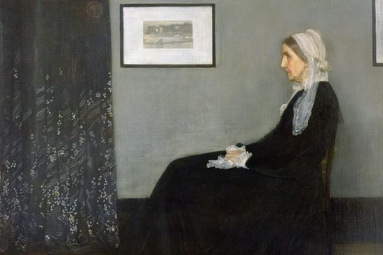 A painting of an elderly woman in profile, seated in a black dress and white cap, hands folded in her lap, against a grey wall with a framed picture, beside a dark patterned curtain — Whistler's "Arrangement in Grey and Black No. 1" (Portrait of the Painter's Mother), 1871.