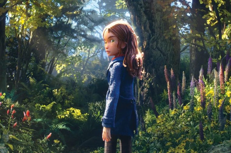 In an animated still, a girl with wavy auburn hair, green eyes, and a textured navy-blue coat stands in profile in a lush forest, her head turned toward the viewer. Golden light filters through tall, mossy trees behind her. In the foreground, tall purple lupines, yellow wildflowers, ferns, and red blossoms fill the undergrowth.
