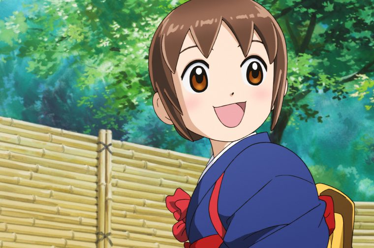 An anime-style illustration of a young person with short brown hair and amber/orange eyes, wearing what appears to be a blue kimono or yukata with red accents. They have a cheerful, smiling expression and are positioned in front of a bamboo fence with lush green foliage in the background. The art style is typical of Japanese animation, with bright, vibrant colors and the characteristic large expressive eyes common in anime character design.