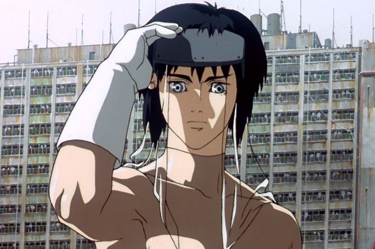 Anime-style illustration of a young person with short black hair wearing what appears to be a VR headset or cybernetic device over their eyes. They have one hand raised to their head in a contemplative pose. The character is shown from the shoulders up against a backdrop of modern urban buildings with multiple floors and windows. The art style is characteristic of cyberpunk anime, with clean lines and muted colors dominated by grays and earth tones.