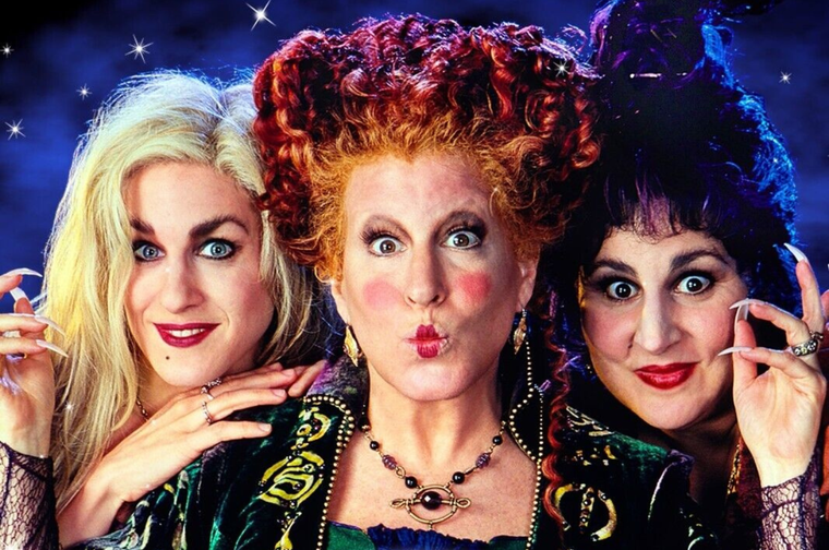 Three witches are shown in the photo - Winifred Sanderson (center) - with the distinctive red curly hair, played by Bette Midler Sarah Sanderson (left) - the blonde sister, played by Sarah Jessica Parker Mary Sanderson (right) - with dark hair, played by Kathy Najimy