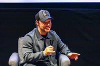 Stephen Graham on a panel discussion for Boiling Point, smiling with microphone