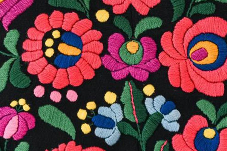 black fabric with colourful floral embroidery on it