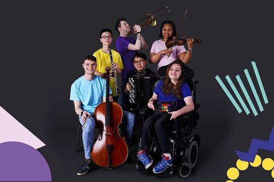 Disabled and neurodivergent young musicians posing for a photo smiling with their instruments, black background and floor. All in black t-shirts.