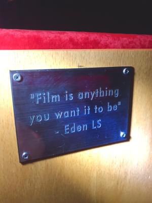 Plaque on cinema chair reading 'film is anything you want it to be'