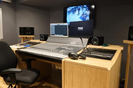 A recording studio, with a main focus on the control desk.