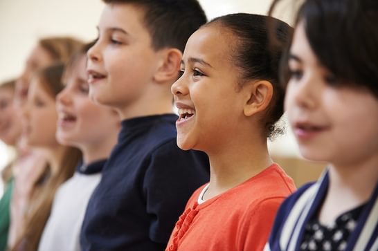 Children are lined up, smiling