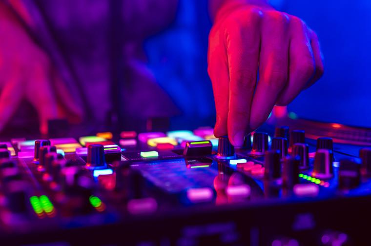 A set of dj decks, with blue and pink lighting