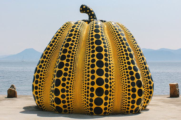 Orange pumpkin with small and large black dots covering it