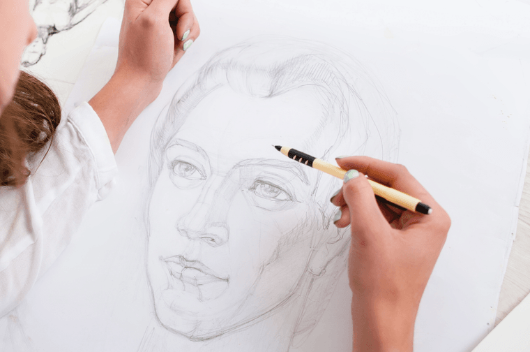 Someone is drawing a face with a pencil