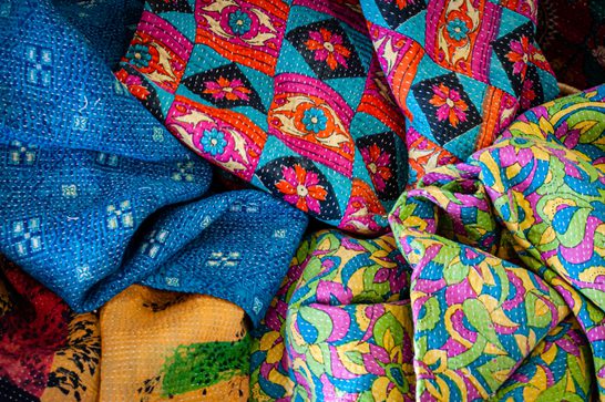 A range of colourful fabrics in a pile