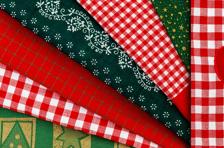 A variety of red, green and white christmas-themed fabrics
