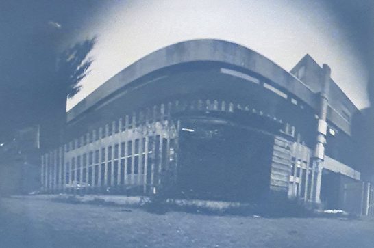 A black and white picture of a building, taken with a pinhole camera