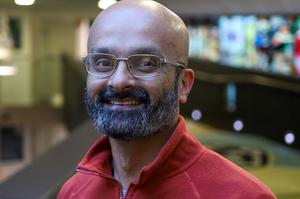 A man with a beard is smiling at the camera