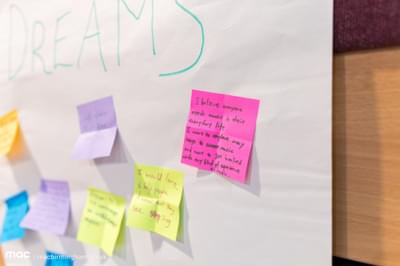 A post it note saying "I believe everyone needs music in their everyday life. I want to explore many ways to access music and want to get involved with any kind of experience of music."