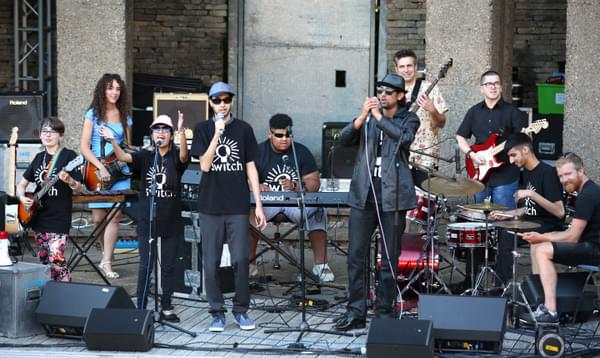 SWITCH band playing a gig at sunset outside