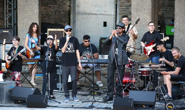SWITCH band playing a gig at sunset outside