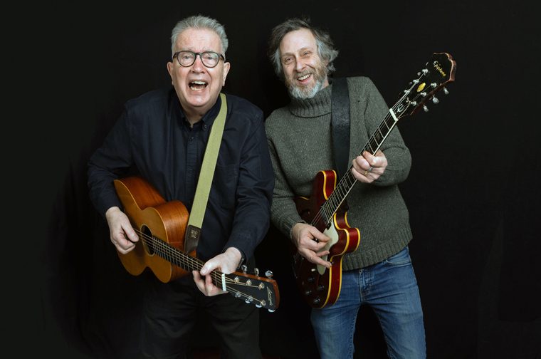 Tom Robinson and Adam Phillips posing with guitars
