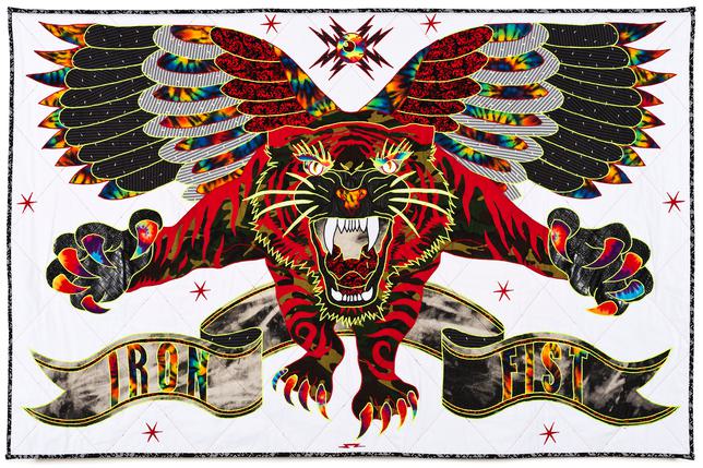 Quilt of a big cat with wings on a white background, a flag below that reads IRON FIST. The big cat is multi-coloured with vibrant reds and big claws and baring teeth.