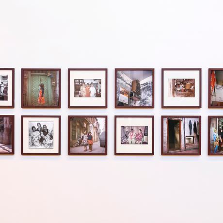 Square photographs taken in Pakistan arranged neatly on an exhibition wall