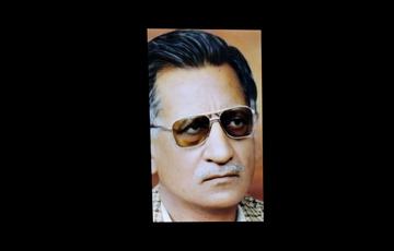 Older man in sunglasses, close-up colour photo on black background